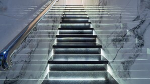 A marble staircase with a handrail, leading to a door at the top. - 13 bedroom Ultimate Private Luxury Compound  with every amenity you can imagine (Sosúa)