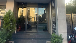 The entrance to La Vie Suits Hotel with a clear glass facade, steps leading up to the entrance, and a sign above the door. - La Vie Suit Hotel (Istanbul)