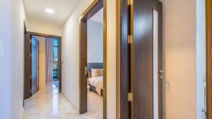 A hallway with a bed, a bathroom, and a view of the outside. - Capacious 3BR Apartment in Bayz Tower, Business Bay by Deluxe Holiday Homes (Dubai)