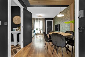 Enjoy meals in this stylish dining area with a round table and comfortable seating.