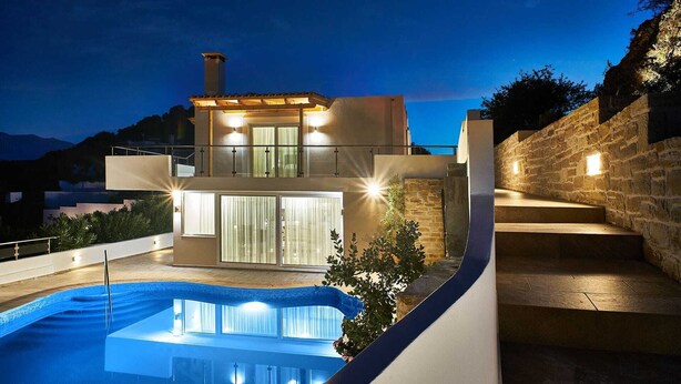 A modern two-story house with a swimming pool, stone walls, and a balcony. - Hannah Villa Stalos: spacious, quiet villa w/sea and mountain view (Chania)