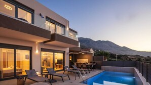 A modern two-story building with a swimming pool, outdoor seating, and a mountain view. - Horizon West Villa │Private Pool, Secluded Luxury Modern Villa (Chania)