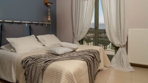 Un dormitorio con cama, cortinas, ventana y radiador.