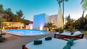 A poolside area with lounge chairs and a small pool. - Villa near Ibiza Town, sleeps 13 (Ibiza)