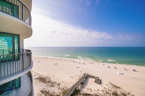 A beach view from a building with a balcony, sandy beach, and ocean. - Phoenix IX 903 - Beautiful 2BR Gulf Front Unit (Orange Beach)