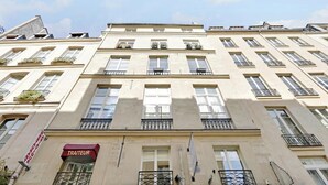 A multi-story building with a flat facade, large windows, and balconies. - AN IDEAL BASE FOR YOUR PARISIAN ADVENTURE, LOCATED AT RUE JACOB - SAINT GERMAIN (Paris)