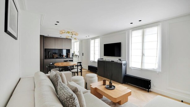 A modern living room with a sofa, coffee table, and dining area. - AN IDEAL BASE FOR YOUR PARISIAN ADVENTURE, LOCATED AT RUE JACOB - SAINT GERMAIN (Paris)