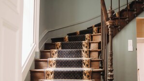 A staircase with a checkered floor and patterned carpet. - The Château and its Orangery (Langeais)