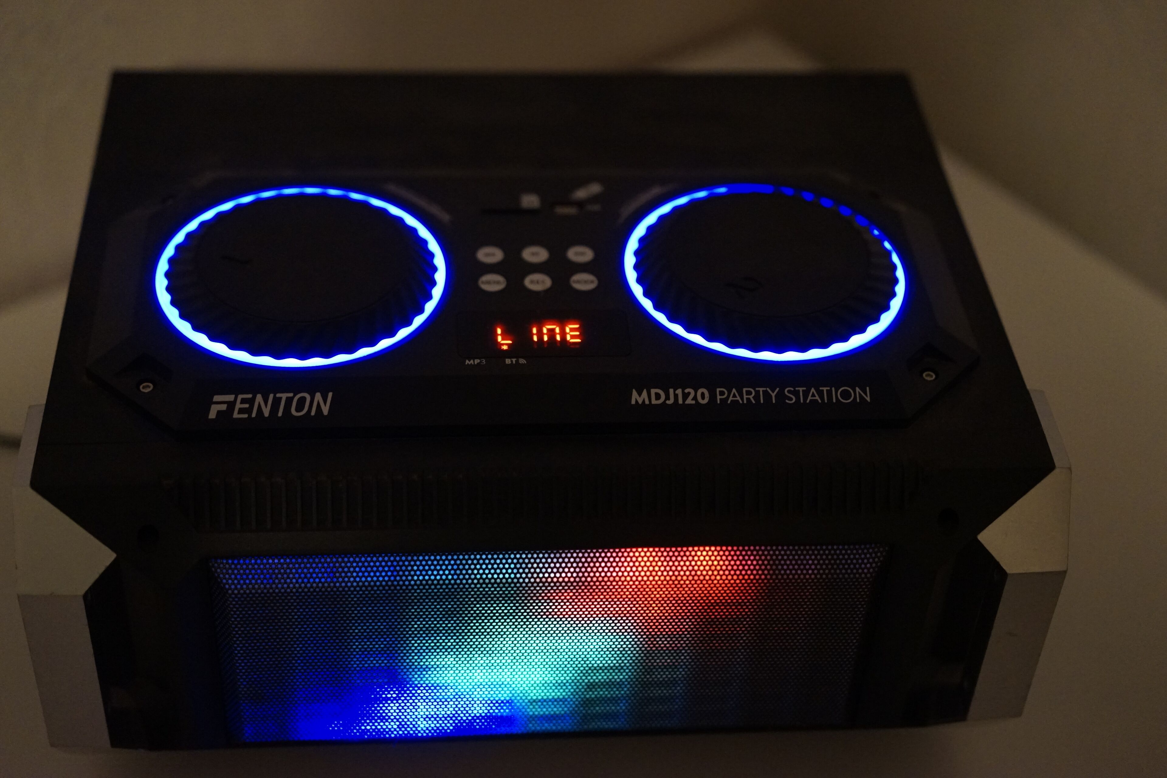 A black DJ equipment with two illuminated blue rings and a digital display.