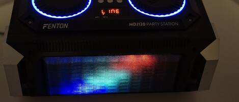A black DJ equipment with two illuminated blue rings and a digital display.