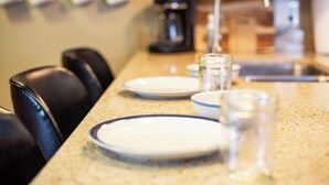 A kitchen counter with plates, glasses, and a coffee maker. - Charming, Unique and Peaceful 3-bedroom Farmhouse on 500 acres in Great Bend, PA (Great Bend)