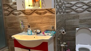 A bathroom with a sink, mirror, and toilet. - ARTISHA TRAVEL HOTEL (Tbilisi)