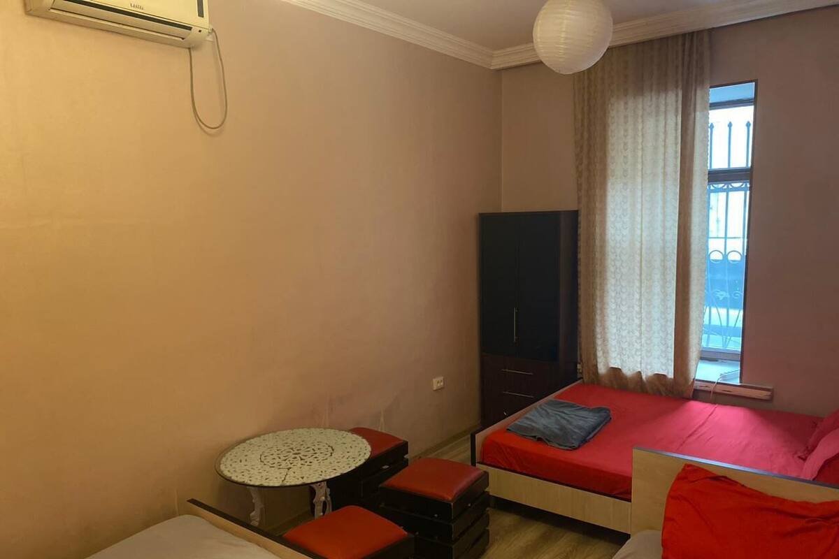 A small, cozy room with a single bed, a desk, and a chair.