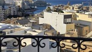 A balcony with a view of a coastal cityscape, including buildings and the sea. - Large 4-bedroom apartment in fantastic Sliema: WiFi, AC -5 min to the Sea-  8ppl (Sliema)