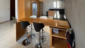 A modern kitchen with wooden cabinets, a black countertop, and a stainless steel refrigerator. - Large 4-bedroom apartment in fantastic Sliema: WiFi, AC -5 min to the Sea-  8ppl (Sliema)