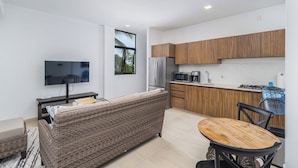 A modern kitchen with wooden cabinets, a built-in microwave, and a gas stove. - DANNY HOUSE 2 (Puerto Vallarta)