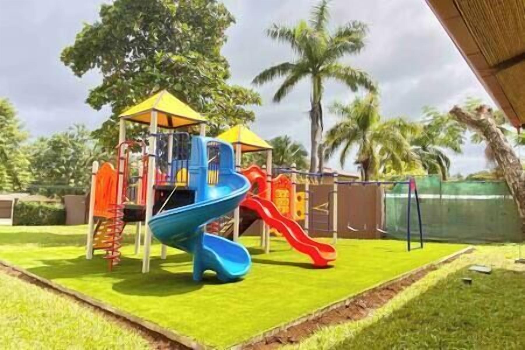 A playground with slides and climbing structures.