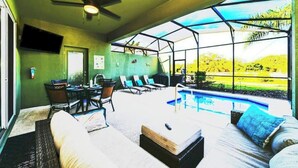 A room with a ceiling fan, a pool, and a view of the outdoors. - 5 bdrm5, ensuites, Pool, free Grill, Solterra4695

 (Davenport)