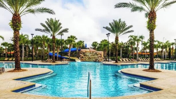 A swimming pool with a water slide, palm trees, and lounge chairs. - 5 bdrm5, ensuites, Pool, free Grill, Solterra4695

 (Davenport)