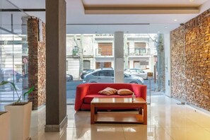 Relax in the comfortable seating area with a view of the street outside.