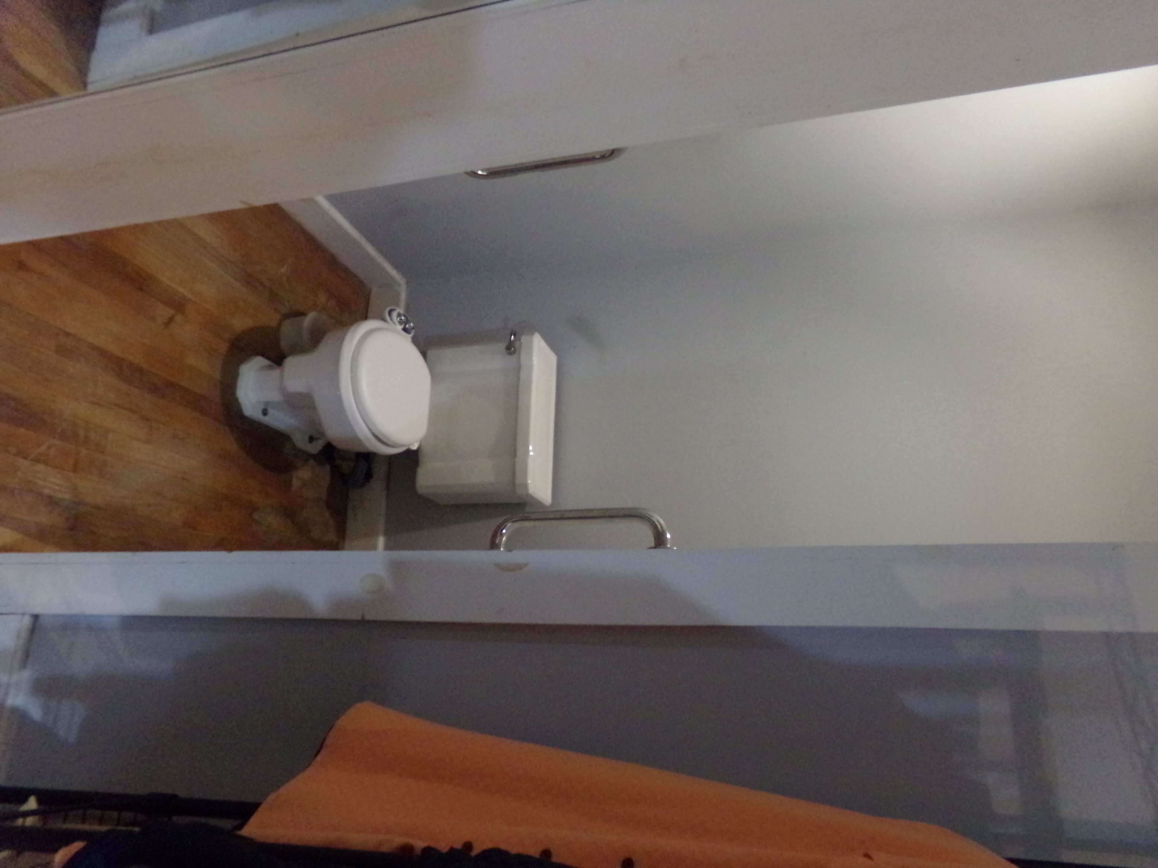 A bathroom with a toilet, a sink, and a shower area.