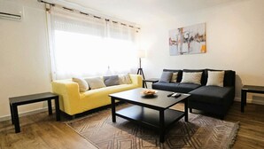A living room with two sofas, a coffee table, and a lamp.
