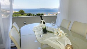 A table set for two with a bottle of champagne, wine glasses, and a bouquet of flowers.