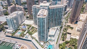 A high-rise hotel with a rooftop pool and surrounding greenery. - Ilikai Hotel Condo at Waikiki No Parking (Honolulu)
