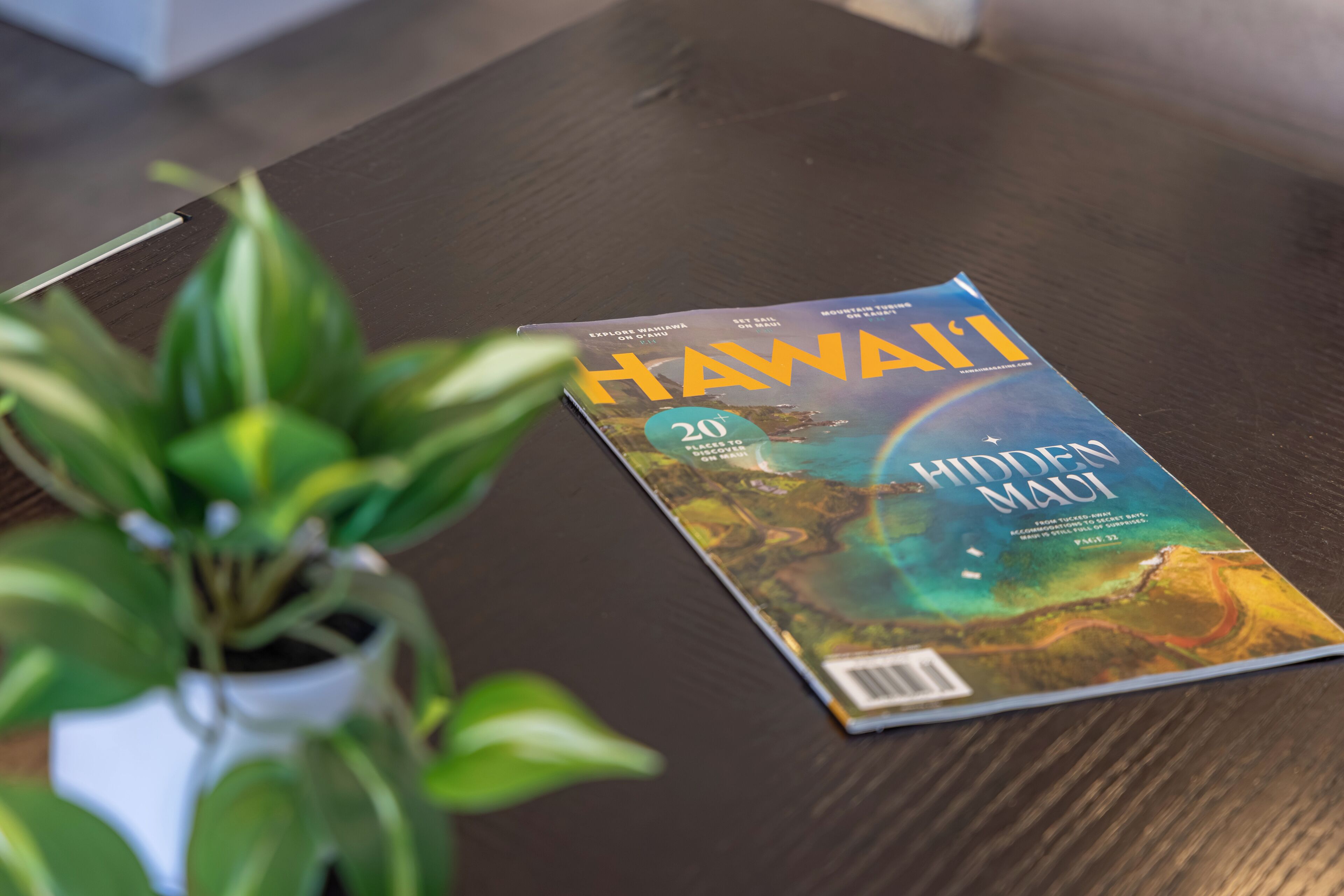 A magazine titled "Hawaii" on a wooden table.