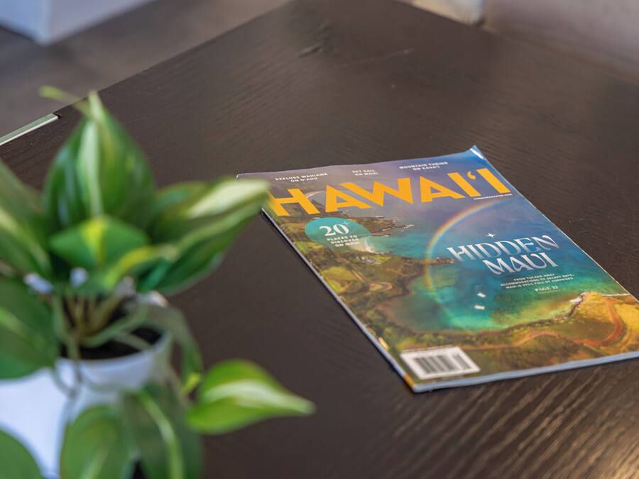 A magazine titled "Hawaii" on a wooden table.