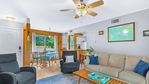 A living room with a sofa, armchairs, a coffee table, and a ceiling fan. - Charming Lakeside Condo - Moments to Lake Fun (Canyon Lake)