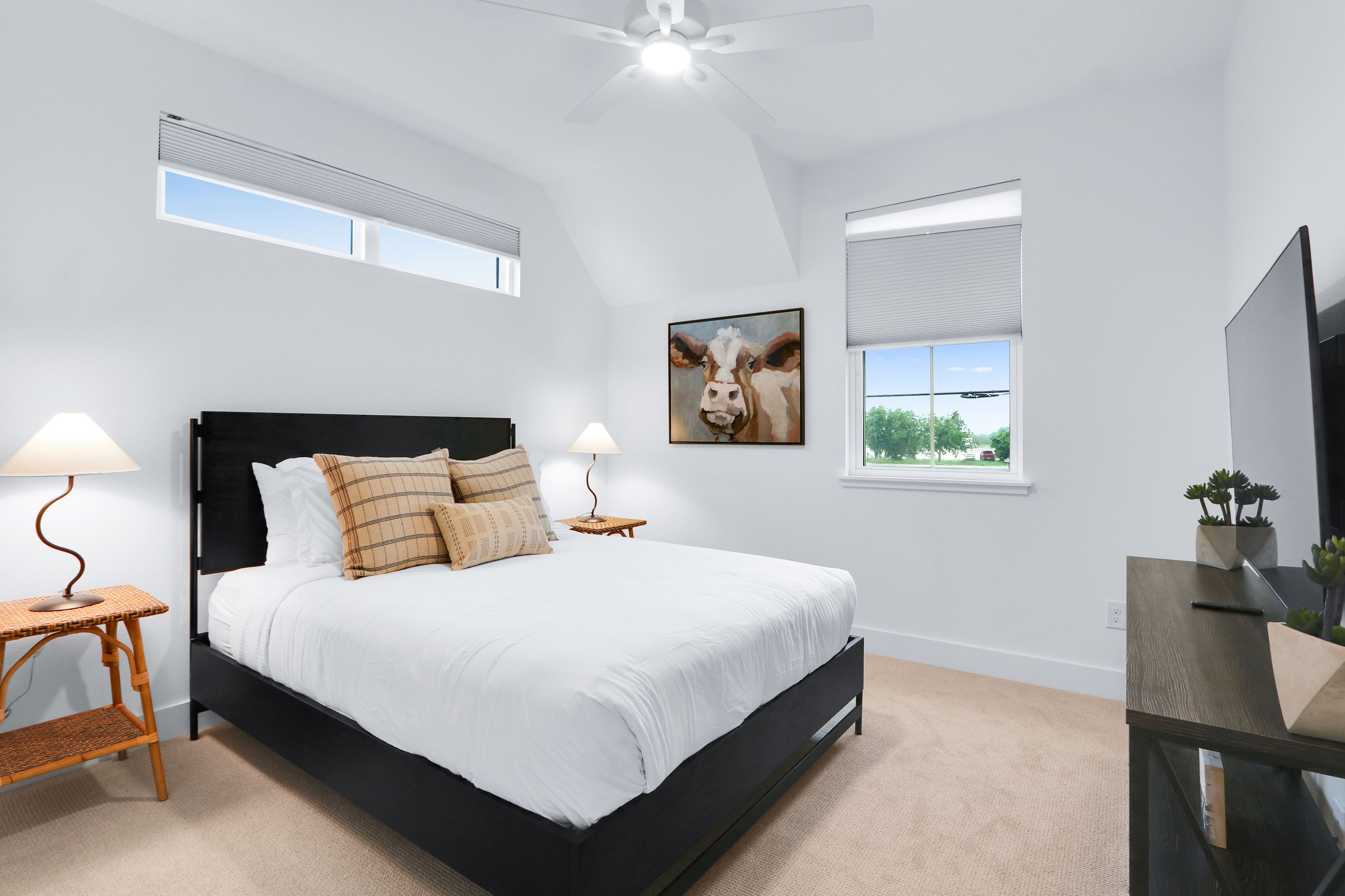 The third bedroom retreat showcases a queen-sized bed & Smart TV