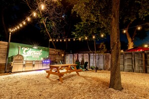 The back yard picnic area boasts a firepit, grill, pizza oven, & outdoor fridge - Best Location in Downtown NB | Golf Cart Included! (New Braunfels)