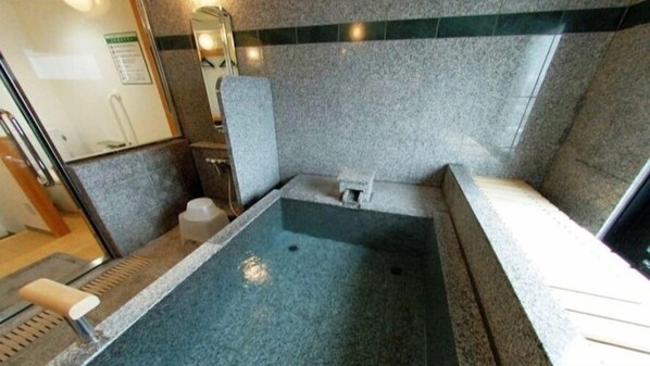 A small, private bathroom with a bathtub, a toilet, and a sink. - Hotel Alpha-One Yonezawa (Yonezawa)