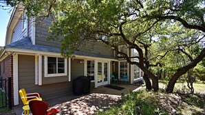 A house with a covered porch, a barbecue grill, and outdoor seating. - Dreamy Dripping Springs | Near Parks, Hiking & More! (Dripping Springs)