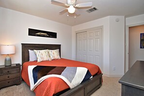 The second bedroom retreat features a plush queen bed & Smart TV