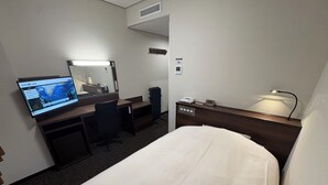 A hotel room with a bed, desk, chair, television, and a nightstand with a lamp. - Hotel Alpha-One Iwaki (Iwaki)
