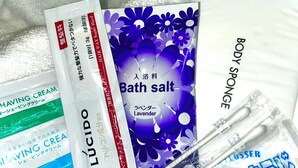 A variety of personal care products including shaving cream, body sponge, and bath salt.