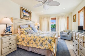 A hotel room with a bed, a desk, a chair, a ceiling fan, and a window with curtains. - "Summer Splendor" OCEAN VIEWS  Private Pool Hot Tub Direct Beach Access!! (Corolla)