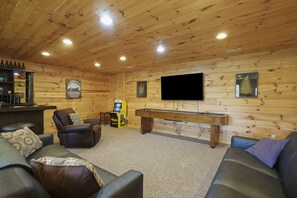 A cozy room with a pool table, leather chairs, a bar area, and a flat-screen TV mounted on the wall. - MeadowLark Lodge | Hocking Hills, Sleeps 20, Views (Logan)