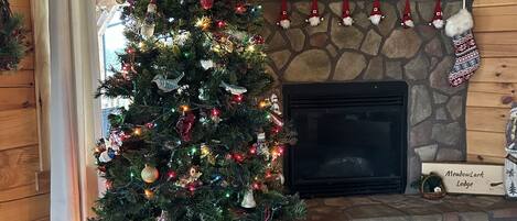 Christmas tree, gnome garland and stockings on mantel.