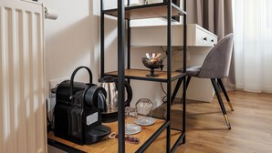 A kitchenette with a coffee maker, kettle, and glass jars on a wooden shelf. - Richter Residence 6 (Brașov)