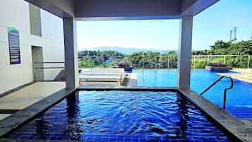 Outdoor pool, a heated pool, open 9:00 AM to 10:00 PM, pool loungers