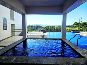 Outdoor pool, a heated pool, open 9:00 AM to 10:00 PM, pool loungers