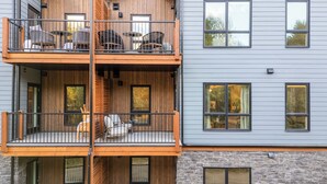 A multi-story building with a wooden balcony and stone facade. - All Year Heated Pool & Tub! New! (Bighorn No. 8)
