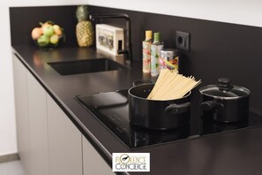 Coffee/tea maker, fridge, microwave, cookware/dishes/utensils