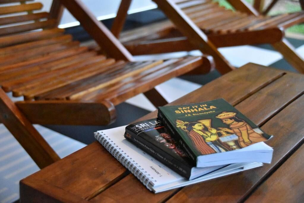 A wooden table with books and a notebook.