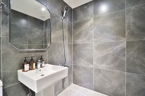 Regadera, secadora de cabello, batas, pantuflas 