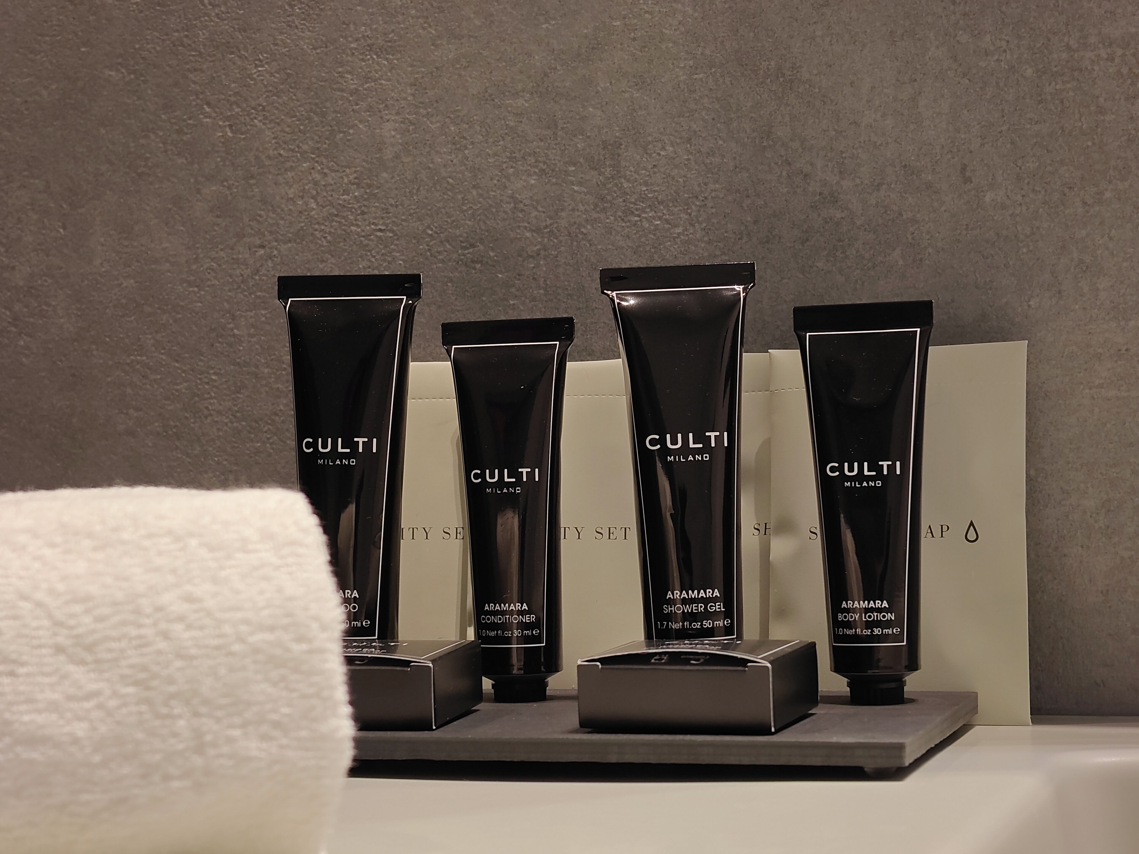 A display of Culti Milano products including conditioner, shower gel, and body lotion.