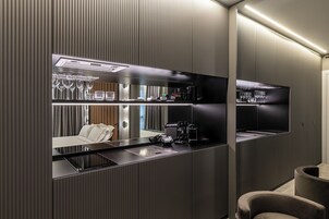 A modern bathroom with a large mirror, a sink, and a toilet.